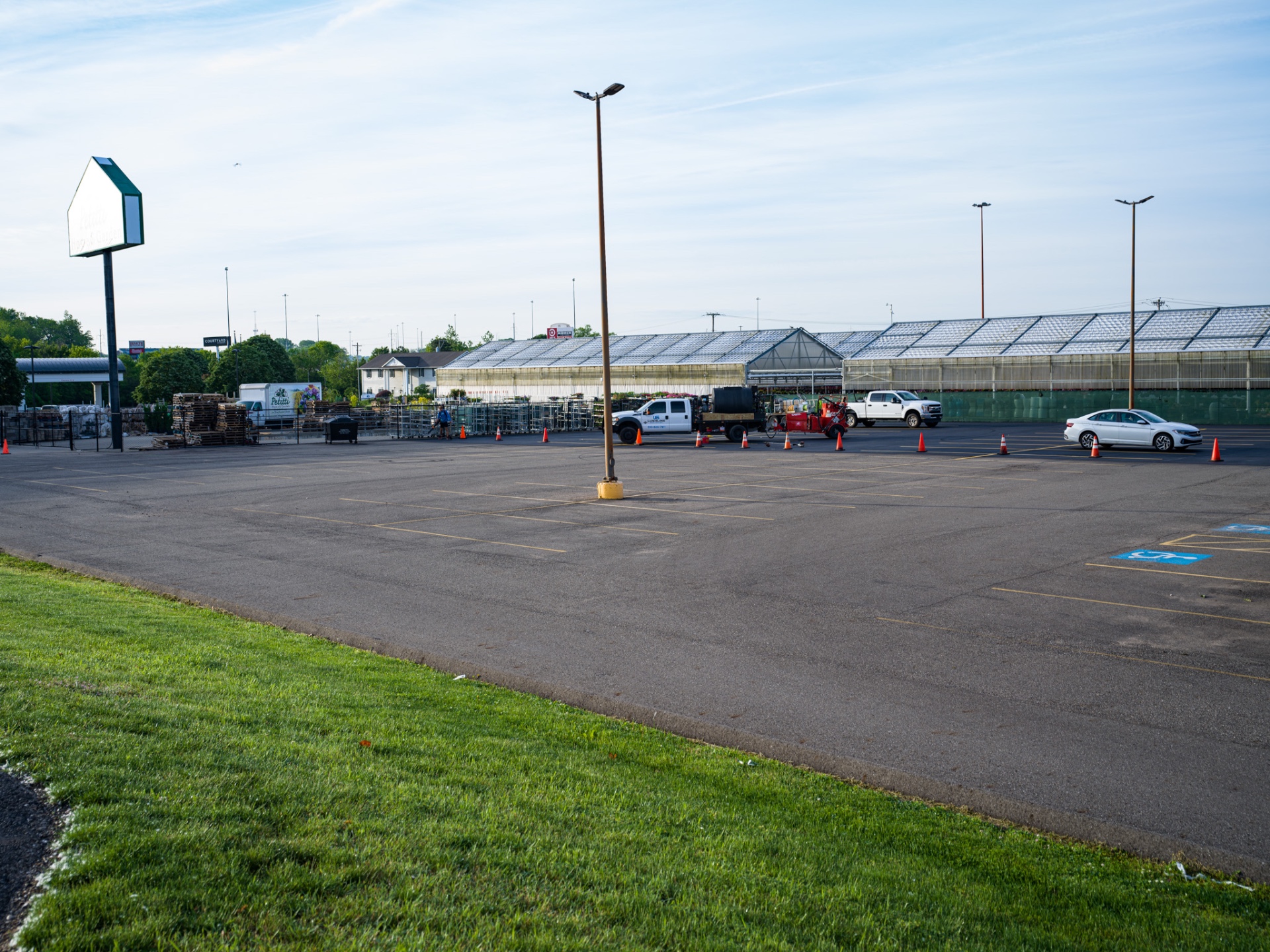 Faded, cracked commercial parking lot before sealcoating in Ohio
