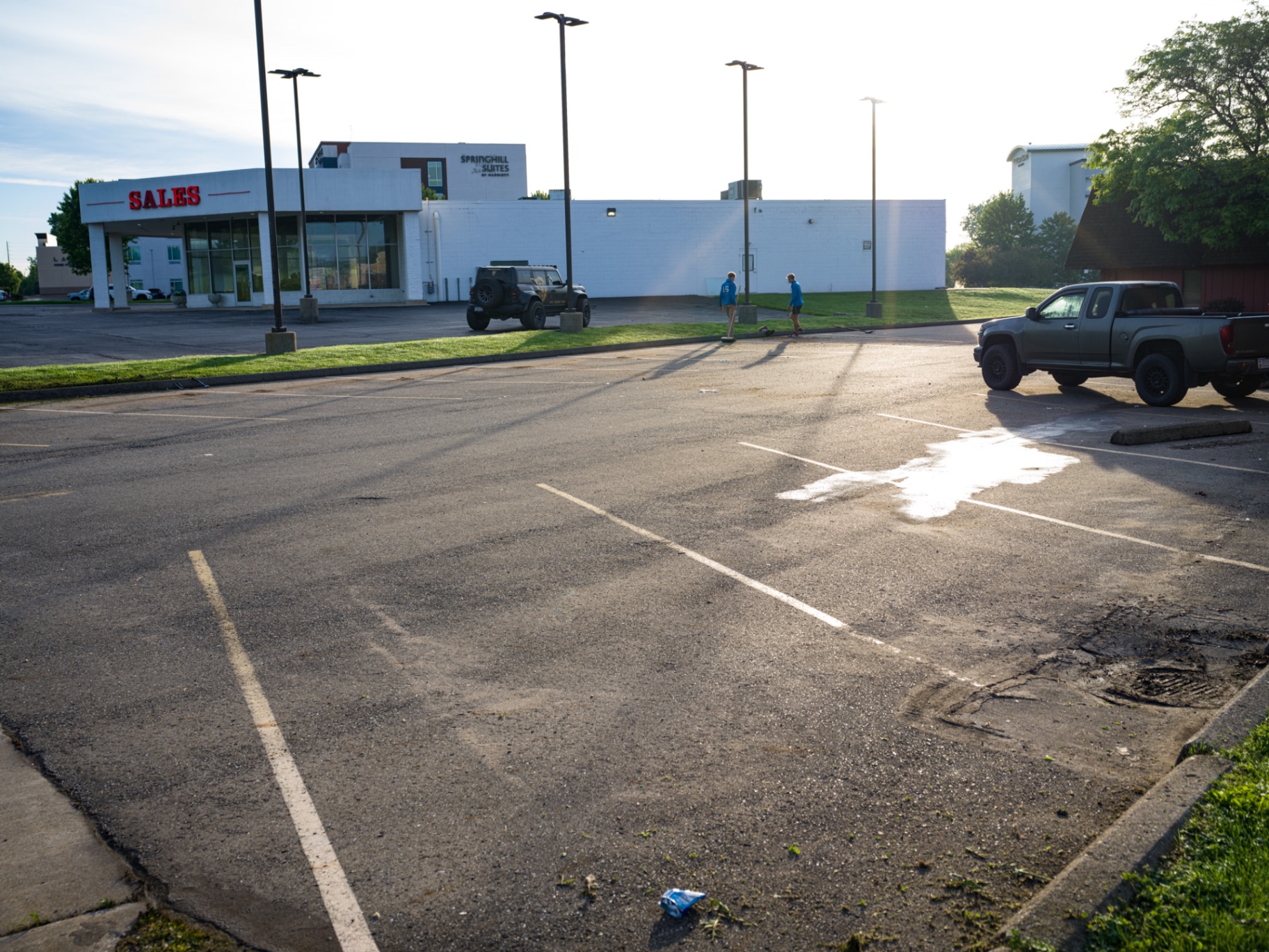 Faded commercial parking lot with worn striping before sealcoating in Ohio